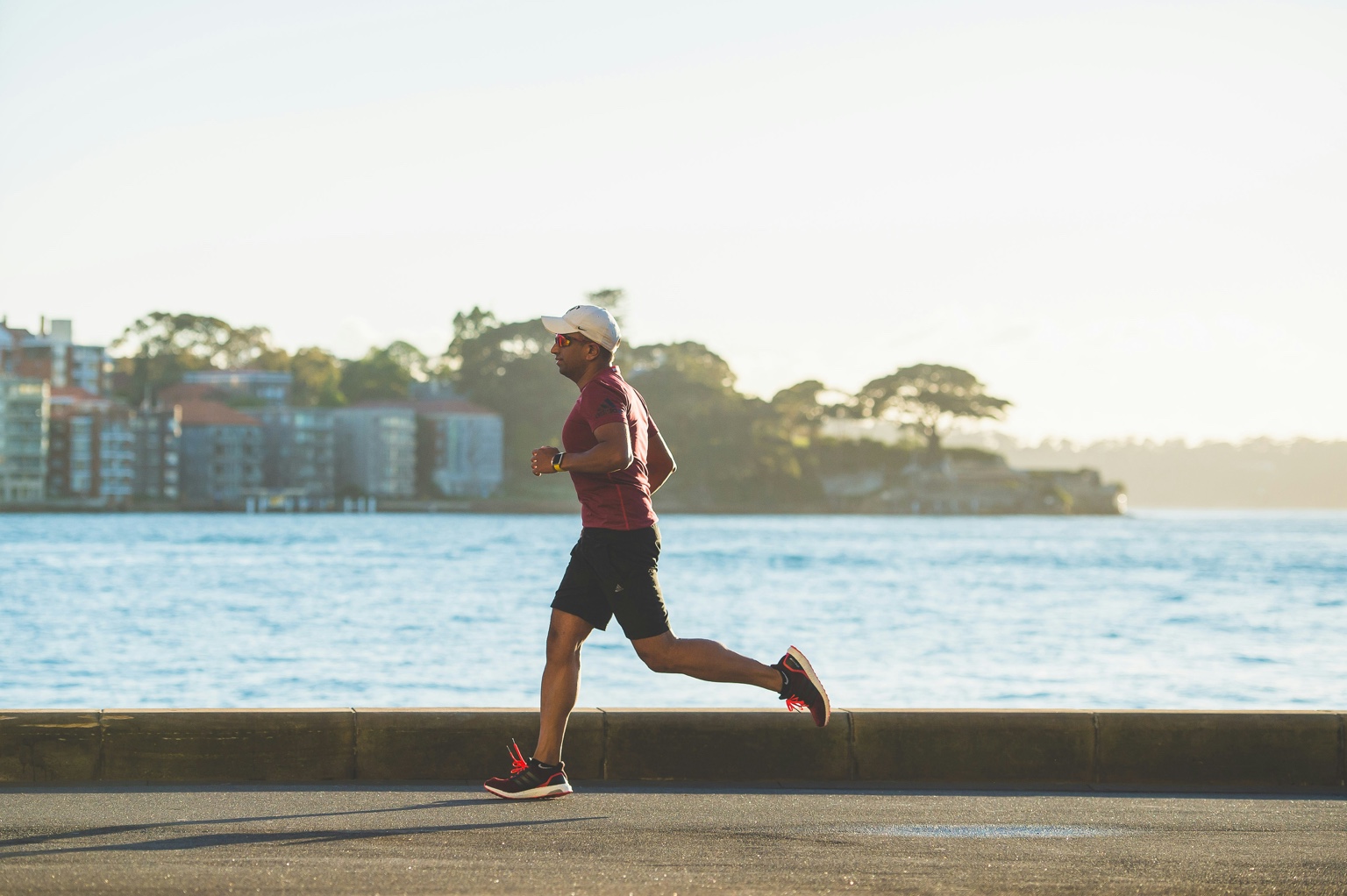 Runner beside the water in morning light